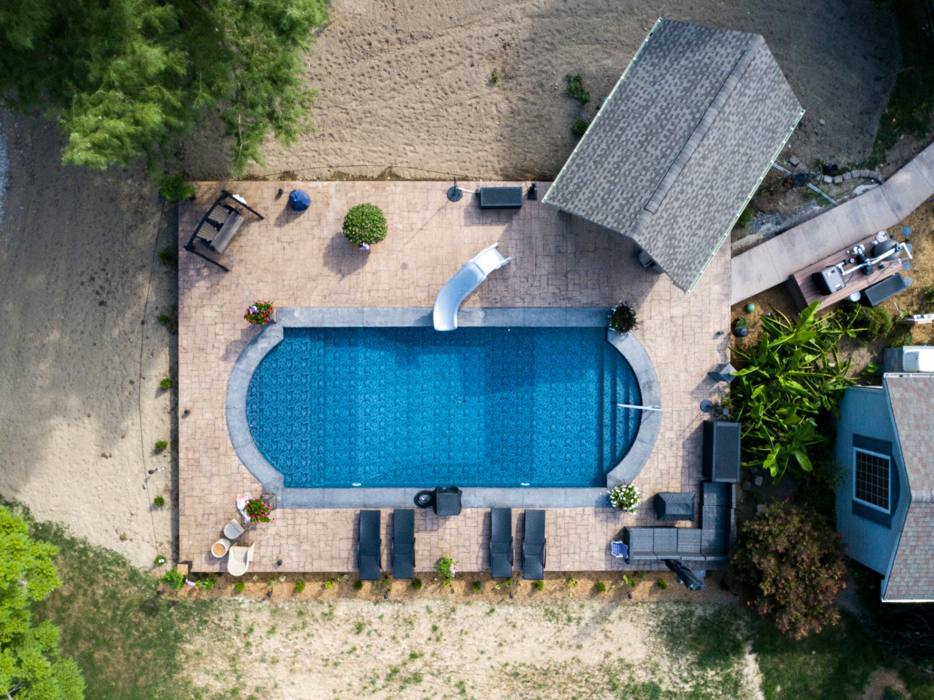Aerial view of Roman-end pool with paver deck